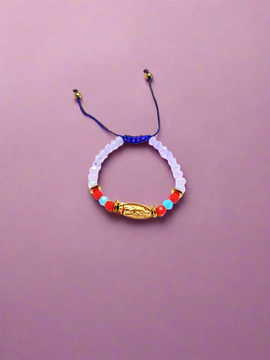 Purple beaded gold colored Guadalupe charm baby, accented with red and blue beads bracelet on a purple background.