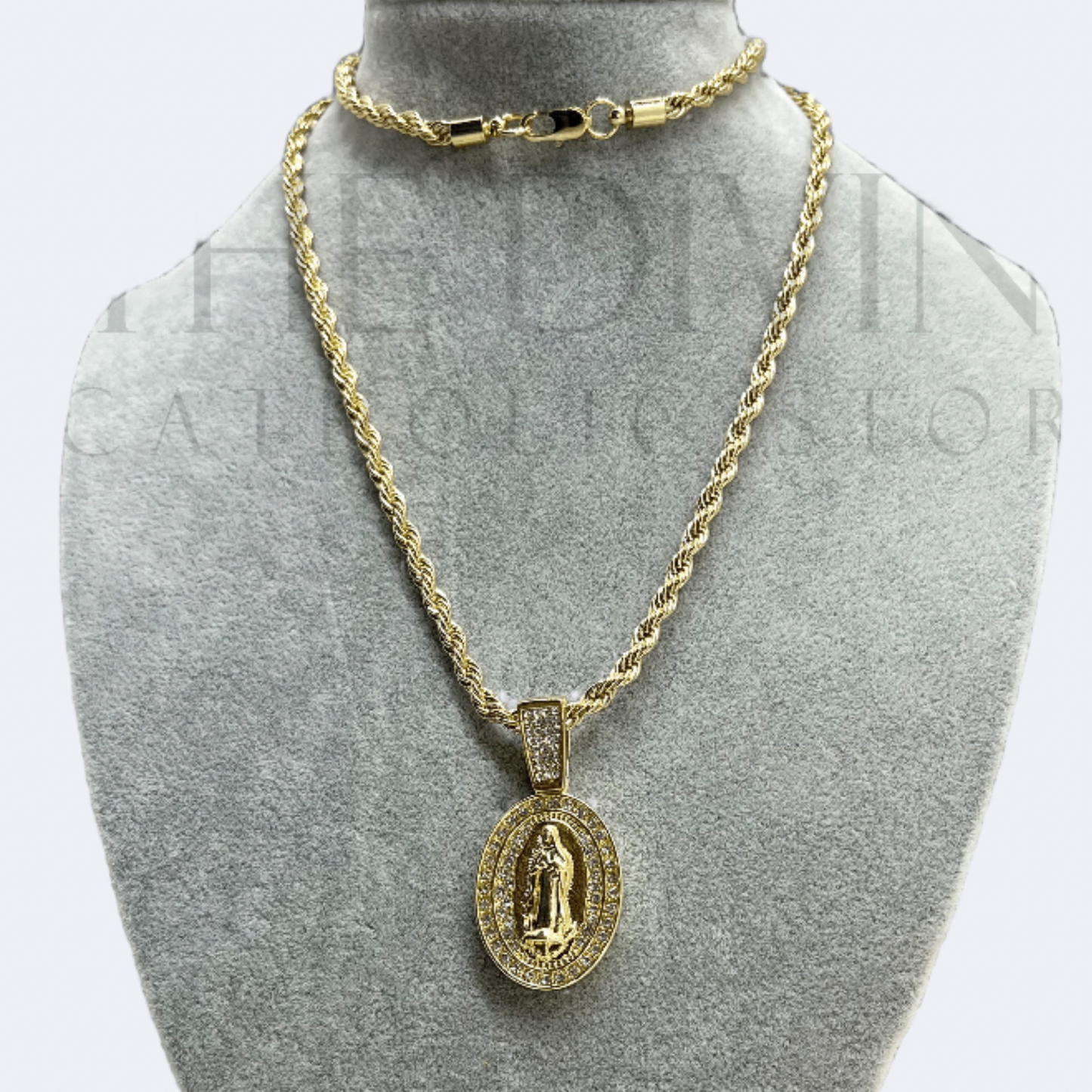 Guadalupe Rope Gold Stainless Steel Necklace featuring an oval pendant with a detailed image of Our Lady of Guadalupe, bordered by sparkling rhinestones, displayed on a sturdy rope chain.
