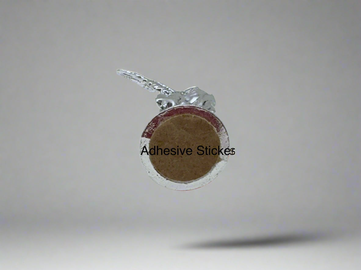 Bottom view of small silver Saint Michael Figurine with adhesive sticker on white background for car or small space