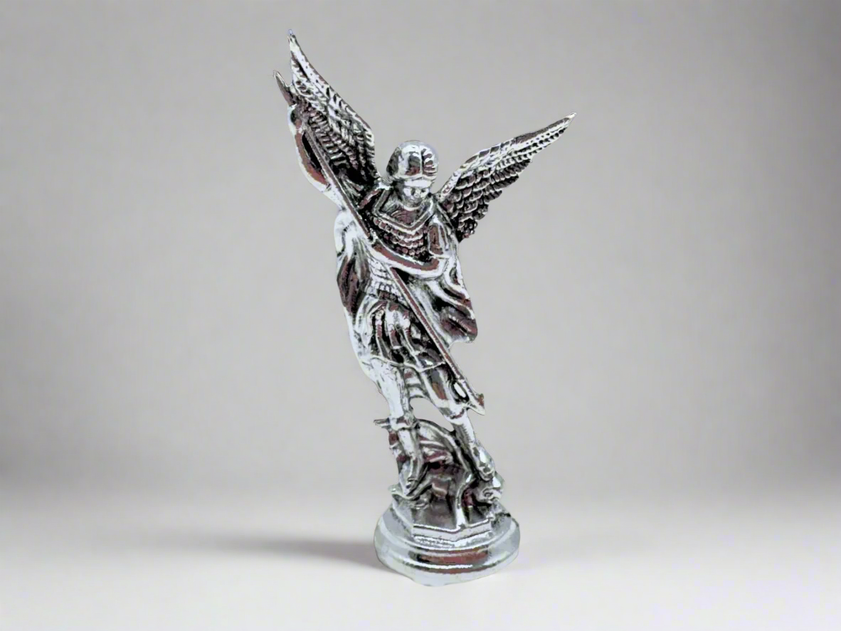 Front view of small silver Saint Michael Figurine on a light gray background
