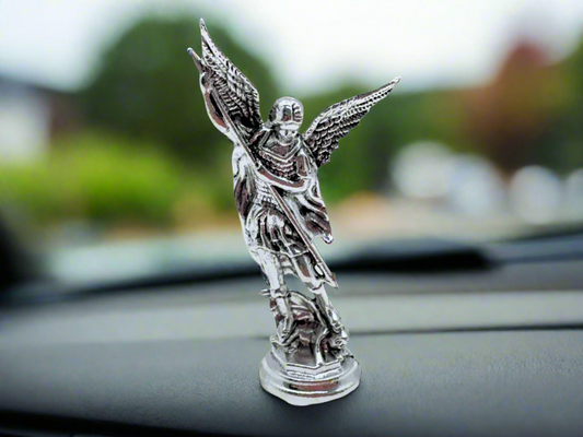 Saint Michael the Archangel dashboard figurine in silver finish placed on car dashboard for Catholic protection