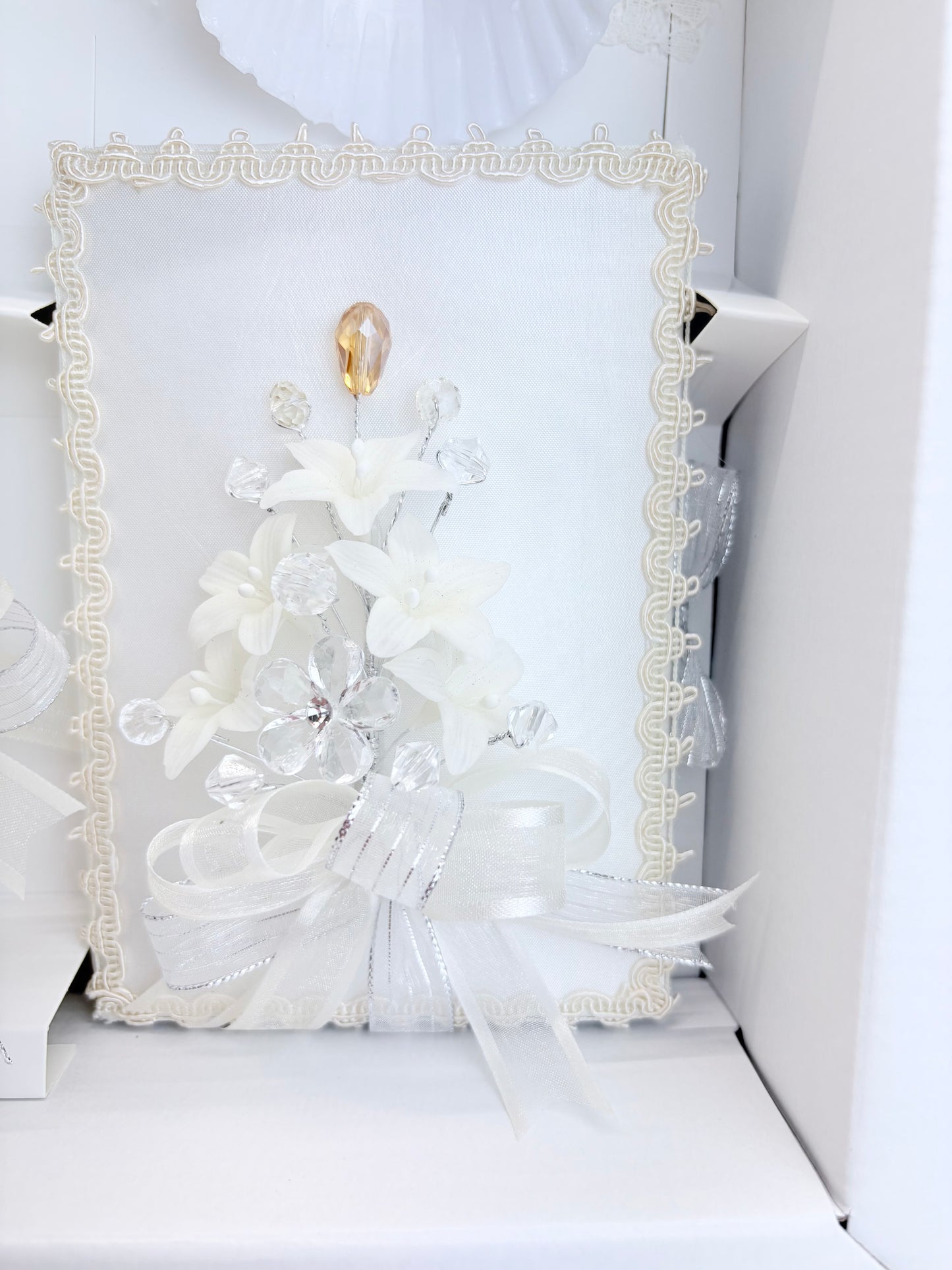 Ivory baptism bible with ivory lace trim crystal floral spray gold teardrop accent and organza bow detail