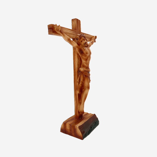 Side view of 15-inch Jesus crucifix statue with crown of thorns, wood-style finish, standing on a base