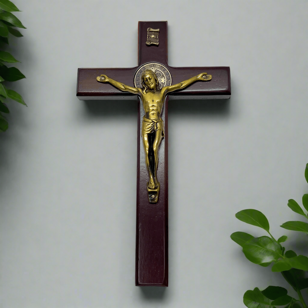 6-inch wooden St. Benedict crucifix mounted on wall with metal hanging loop, for home or office devotional display.
