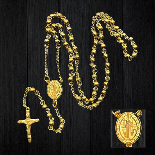 Durable Catholic rosary with stainless steel beads and gold colored St. Benedict medal center piece on a black background.
