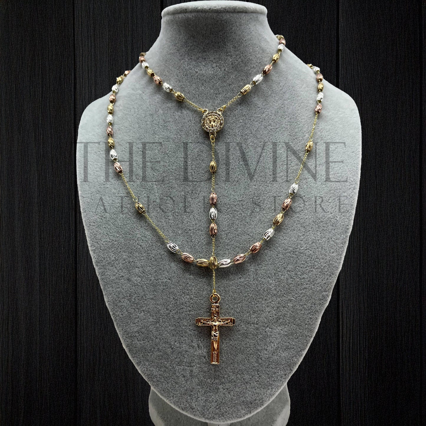Stainless steel rosary with rhinestone St. Benedict medal presented on gray bust with black background.