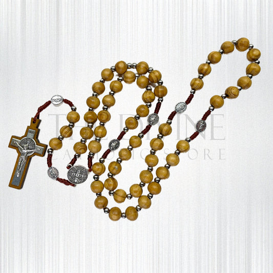 Handmade beige wooden rosary with St. Jude pater beads and St. Benedict centerpiece on a white background.