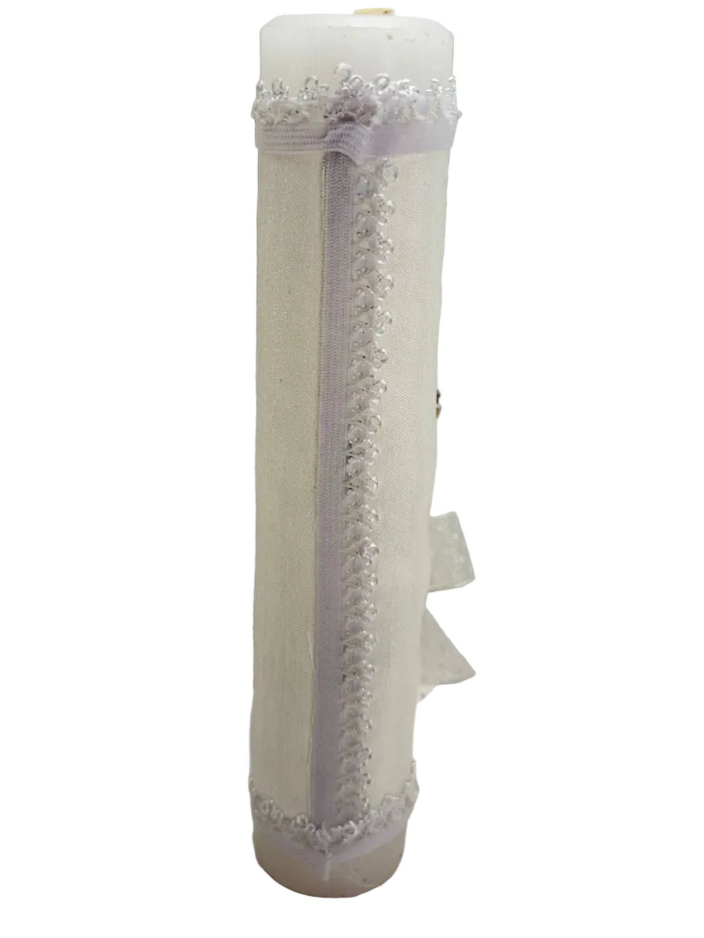 Side view of white fabric wrapped baptism candle with decorative trim