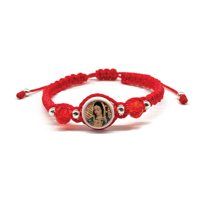 Guadalupe Charm bracelet, woven and made of red nylon, with silver and red beads on white background.