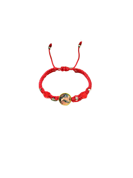 Red woven baby bracelet with Our Lady of Guadalupe charm, silver beads, and adjustable cord for infants aged 0–12 months on a white background