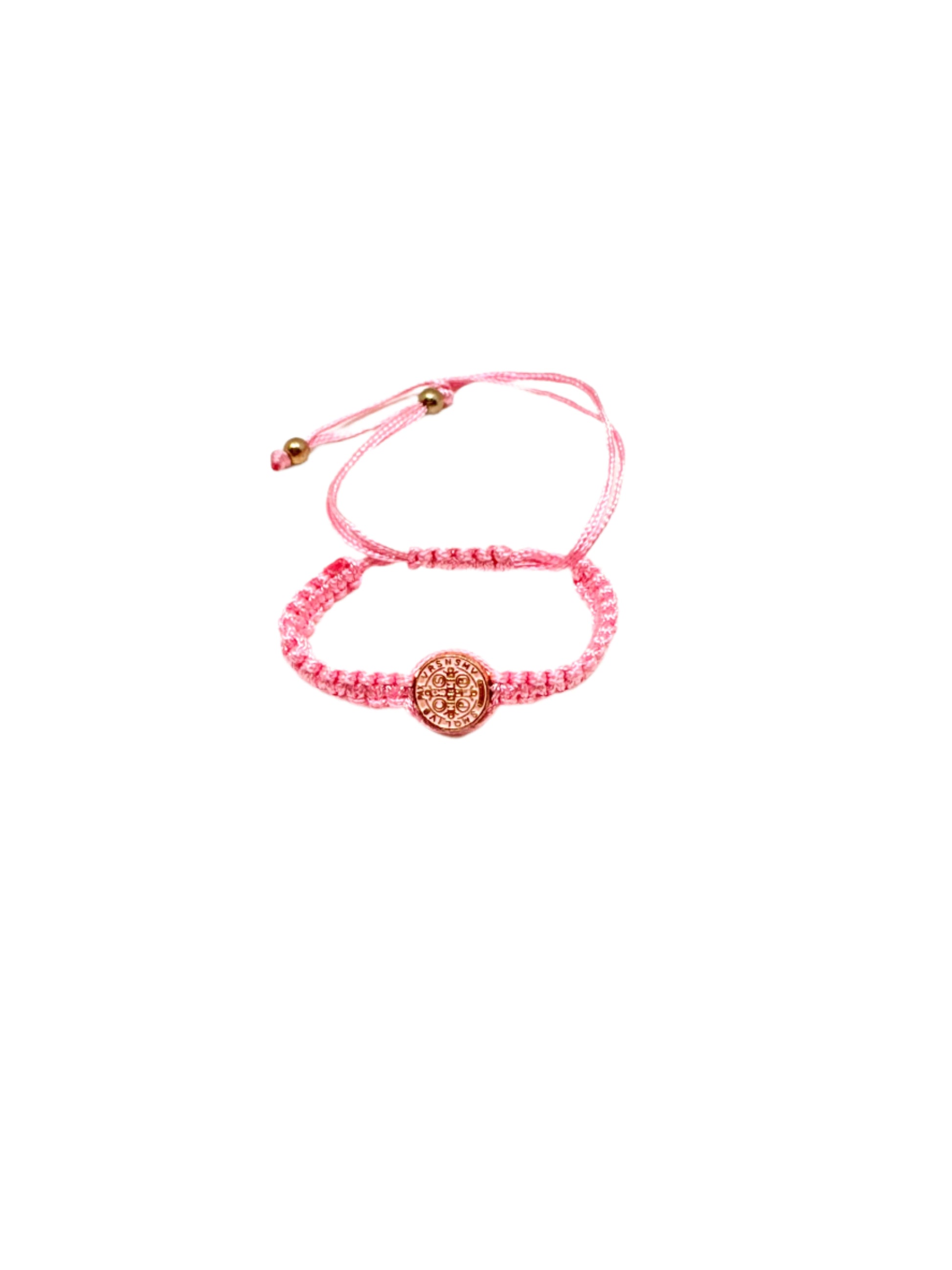 Pink St. Benedict baby bracelet braided bracelet with a circular St. Benedict medal charm on a white background.