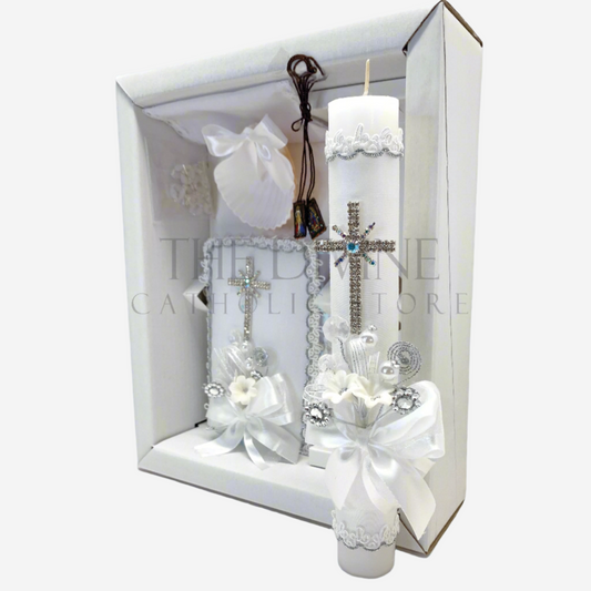 The image features a beautifully designed 6-piece baptism candle set, including a candle, a towel, rosary, bible, scapular, and a shell. The candle is adorned with white fabric, a braided nylon rope design, small white flowers, ribbon and rhinestone embellishments, giving it an elegant and sacred look. 