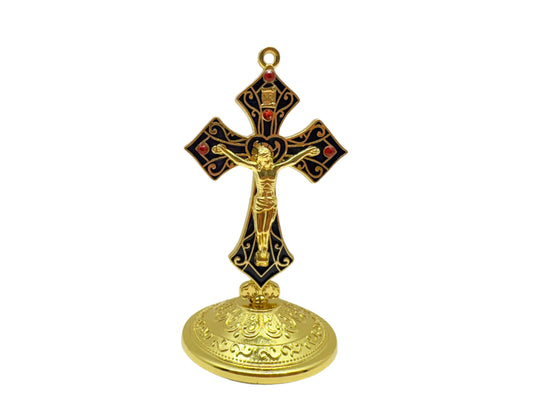 Front view of decorative saint Benedict crucifix with gold and navy design and red rhinestone accents on a white background