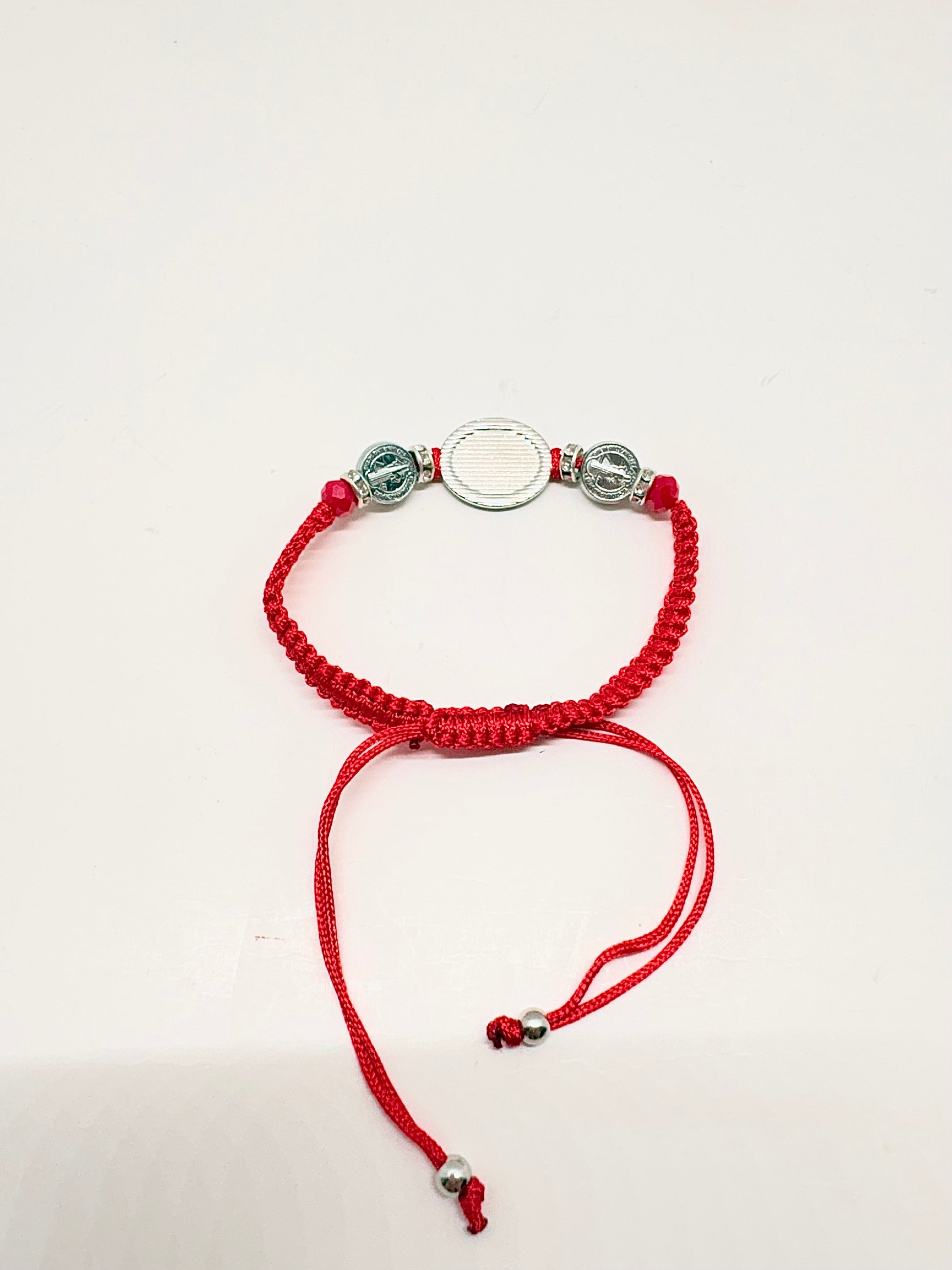 Back view of red Threaded St. Benedict Silver Medal Bracelet Adjustable  with silver beads on a white background