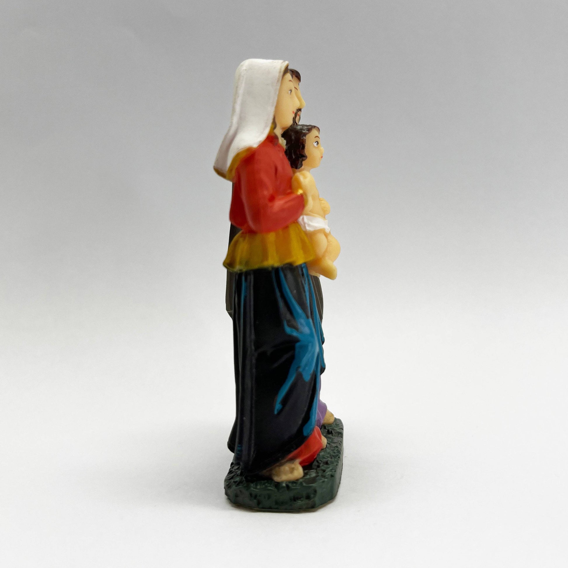 Side view of 3 inch Holy Family Catholic statue showing Mary holding Baby Jesus resin figurine
