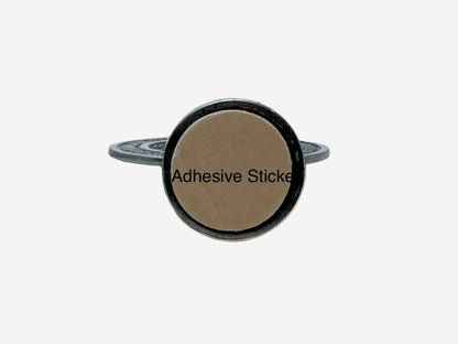 Dashboard St Benedict Medal  in silver bottom view with round adhesive sticker with a beige center and black text on a white background