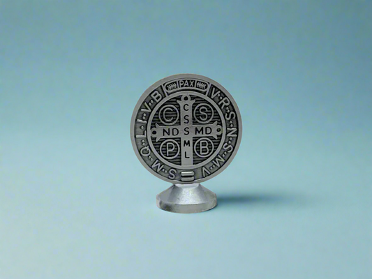 Silver St. Benedict dashboard medal with adhesive base, 2x2 inch Catholic car figure on a blue background. 