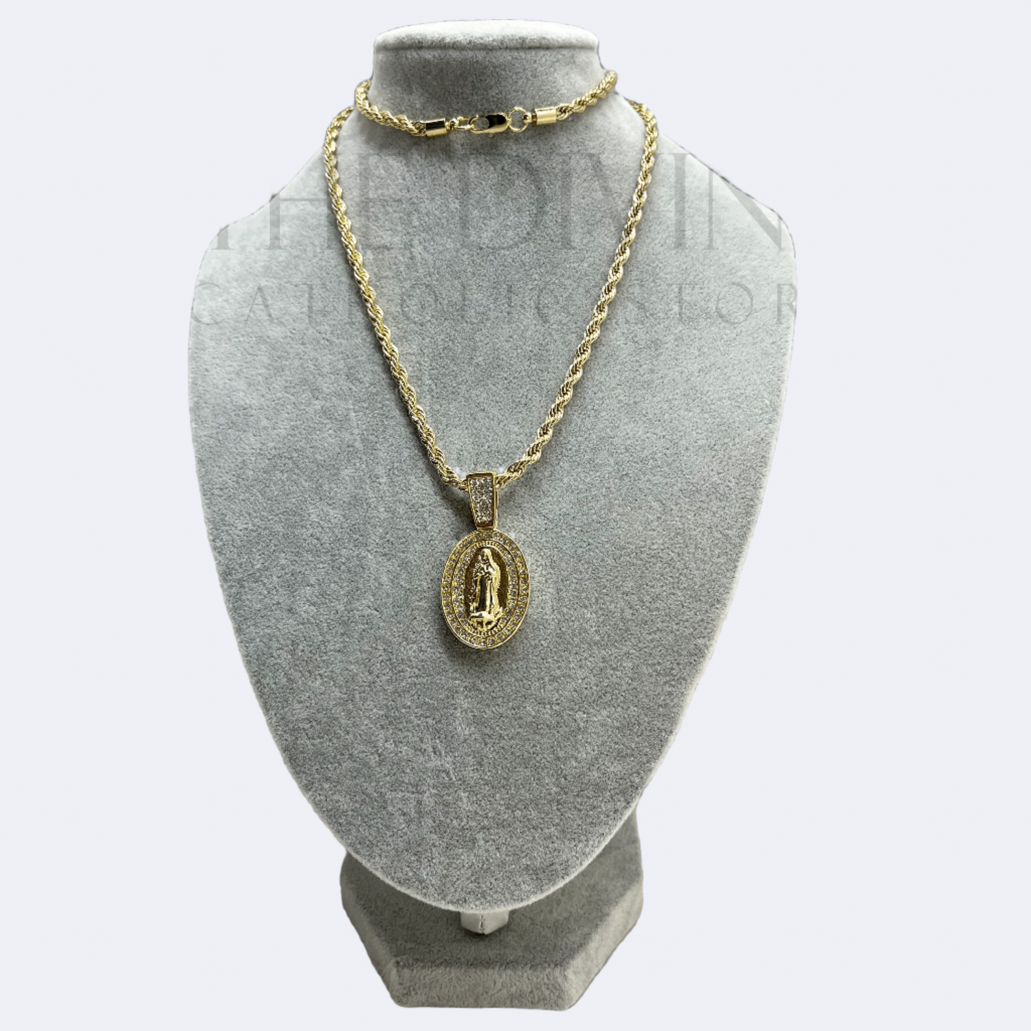 Guadalupe Rope Gold Stainless Steel Necklace featuring an oval pendant with a detailed image of Our Lady of Guadalupe, bordered by sparkling rhinestones, displayed on a sturdy rope chain.
