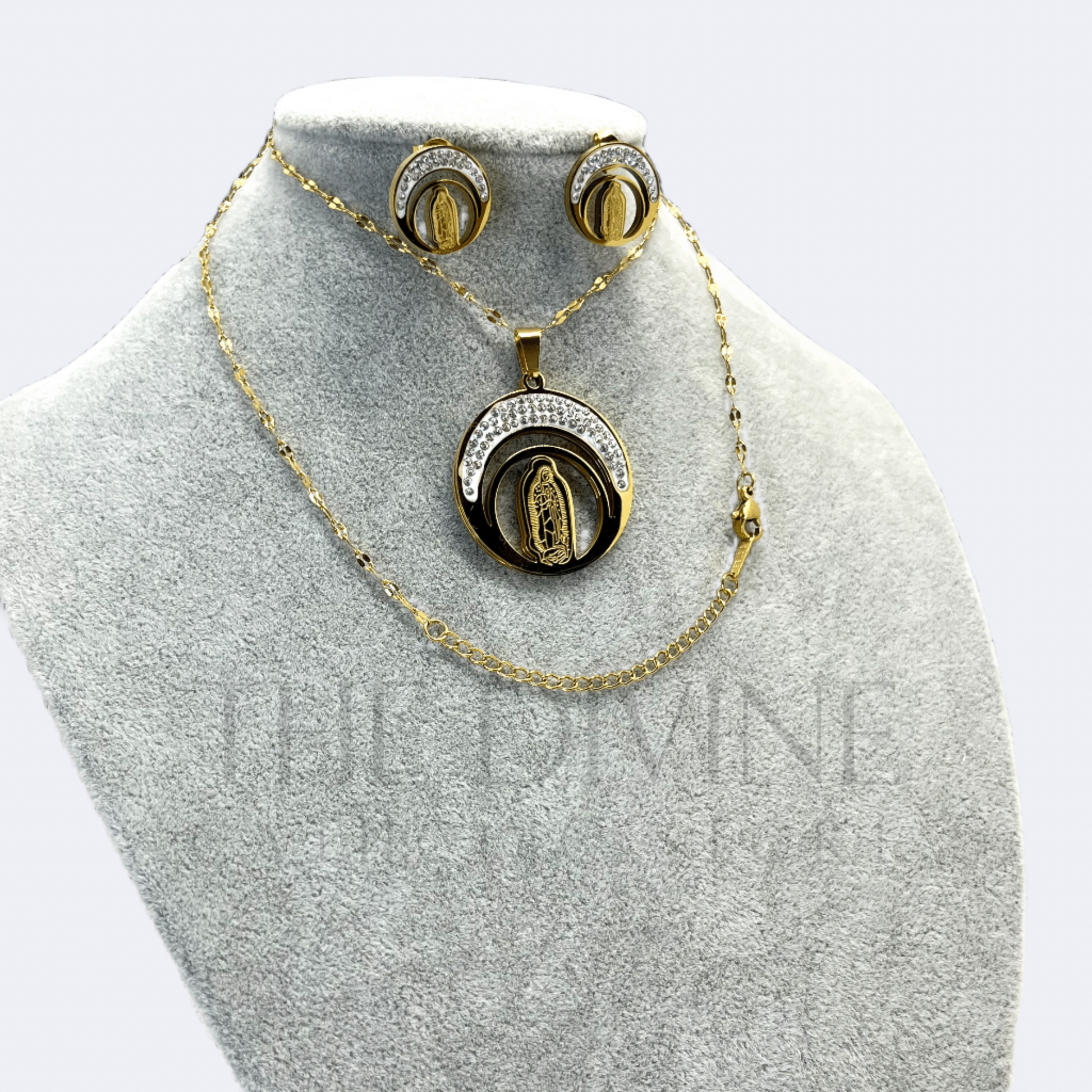 Our Lady of Guadalupe Moon Necklace and Earring Set in stainless steel, featuring a detailed pendant of the Virgin of Guadalupe against a crescent moon, with matching earrings, displayed on a neutral background.