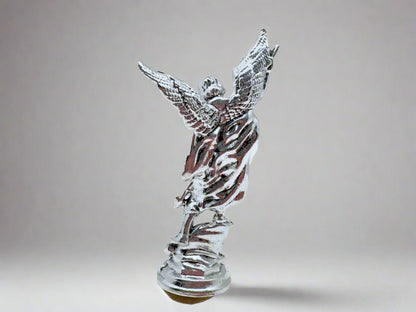 Back  view of small silver Saint Michael Figurine on white background 