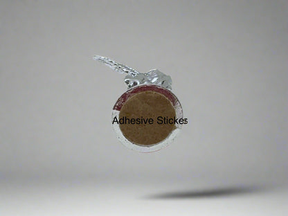 Bottom  view of small silver Saint Michael Figurine with adhesive sticker on white background for car or small space