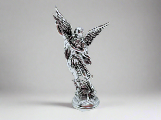 Front view of small silver Saint Michael Figurine on a light gray background 