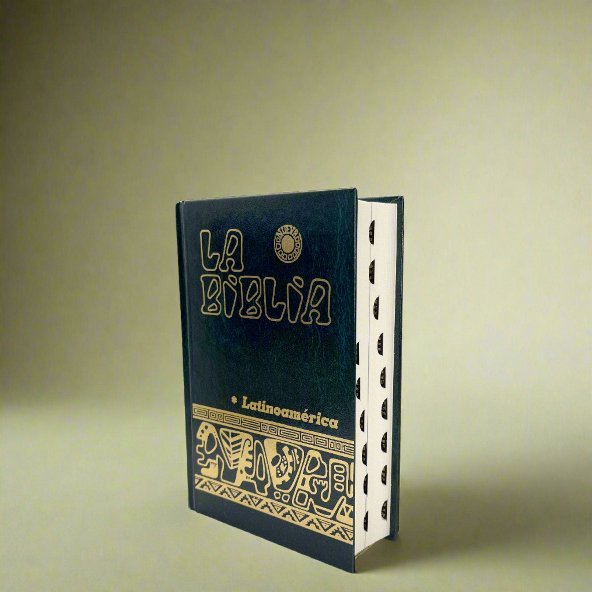 La Biblia Latinoamericana pocket-sized Bible with a green cover and indexed tabs for easy navigation with green background.