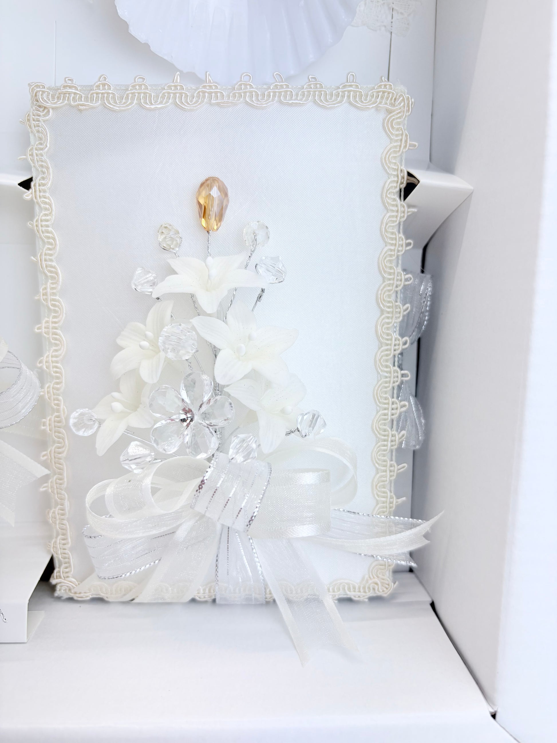 Ivory baptism bible with ivory lace trim crystal floral spray gold teardrop accent and organza bow detail