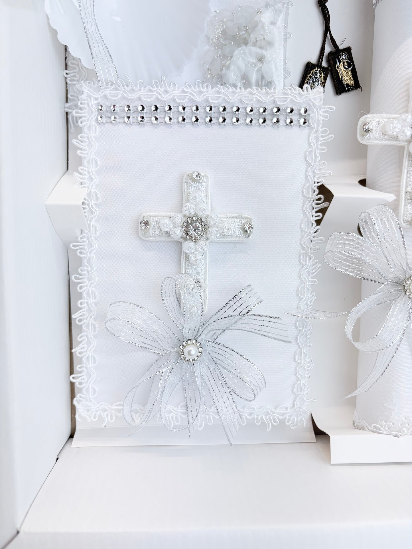 White baptism bible with rhinestone band lace rose cross rhinestone cluster center and silver organza bow pearl accent