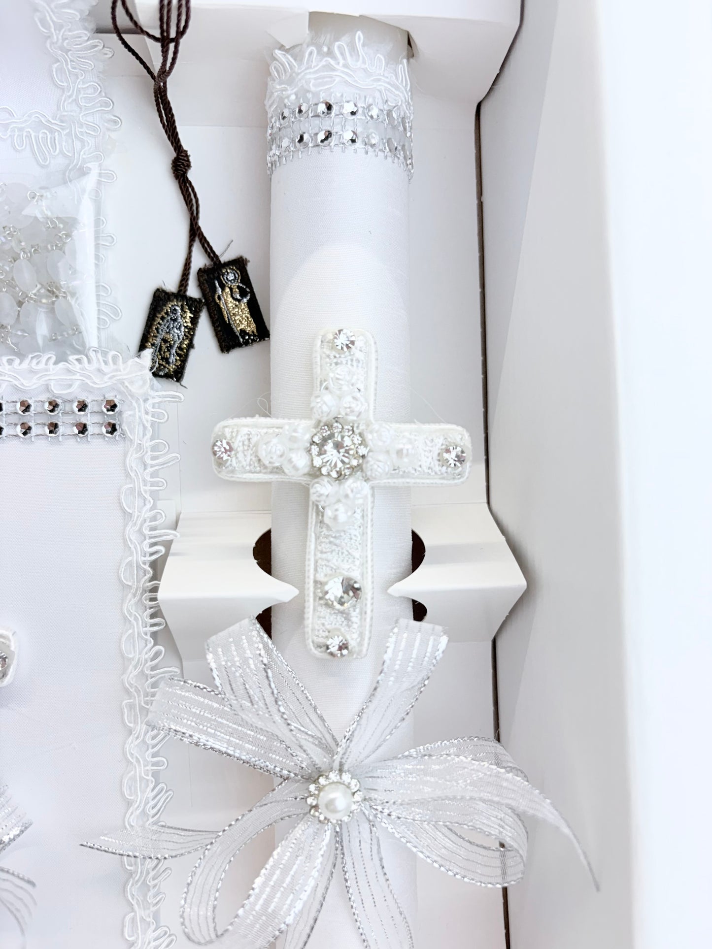 White baptism candle with lace rose cross and our lady of guadalupe st jude gold stitched scapular detail