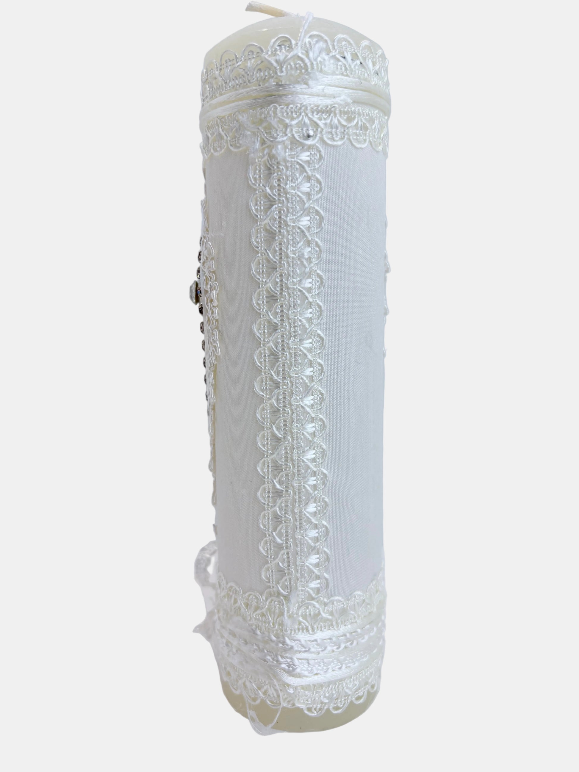 Back view of ivory baptism candle showing full white lace wrap with satin ribbon and delicate lace border