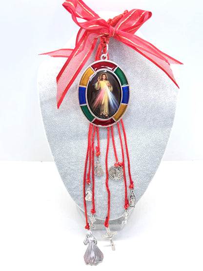 Close-up of Divine Mercy pendant with multicolor frame on red door hanger
