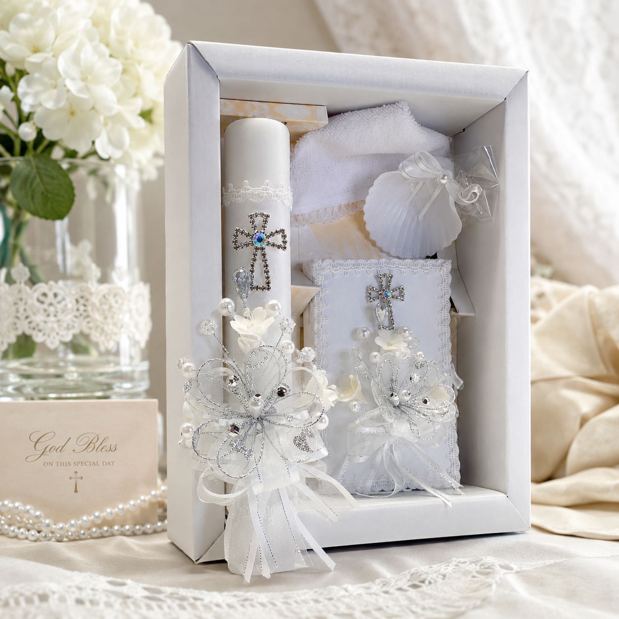 Elegant 5-piece Catholic baptism gift set with ivory baptism candle, prayer book, shell, towel, and rosary displayed in a keepsake box.