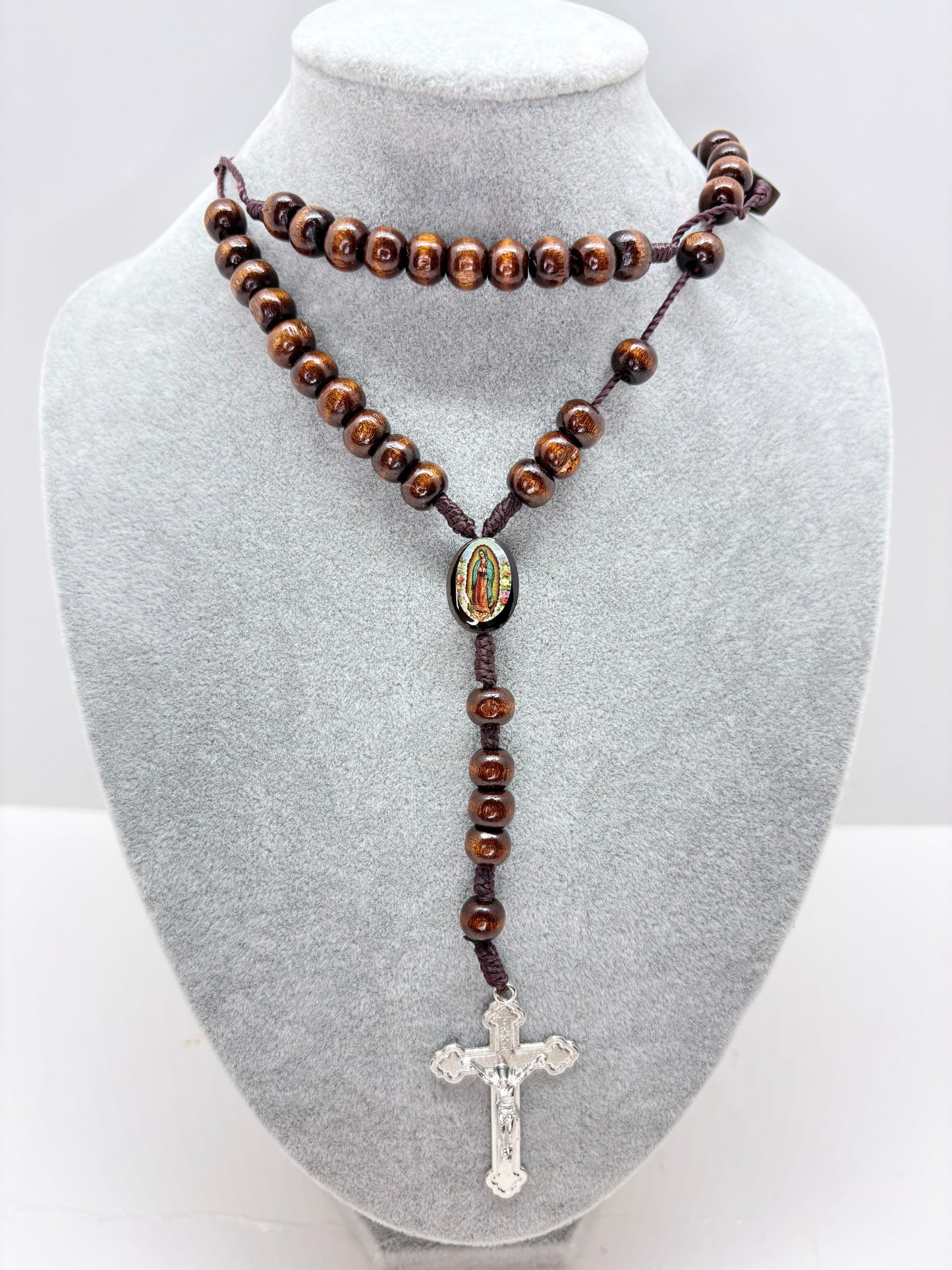 Wooden Catholic rosary displayed with St Benedict style crucifix