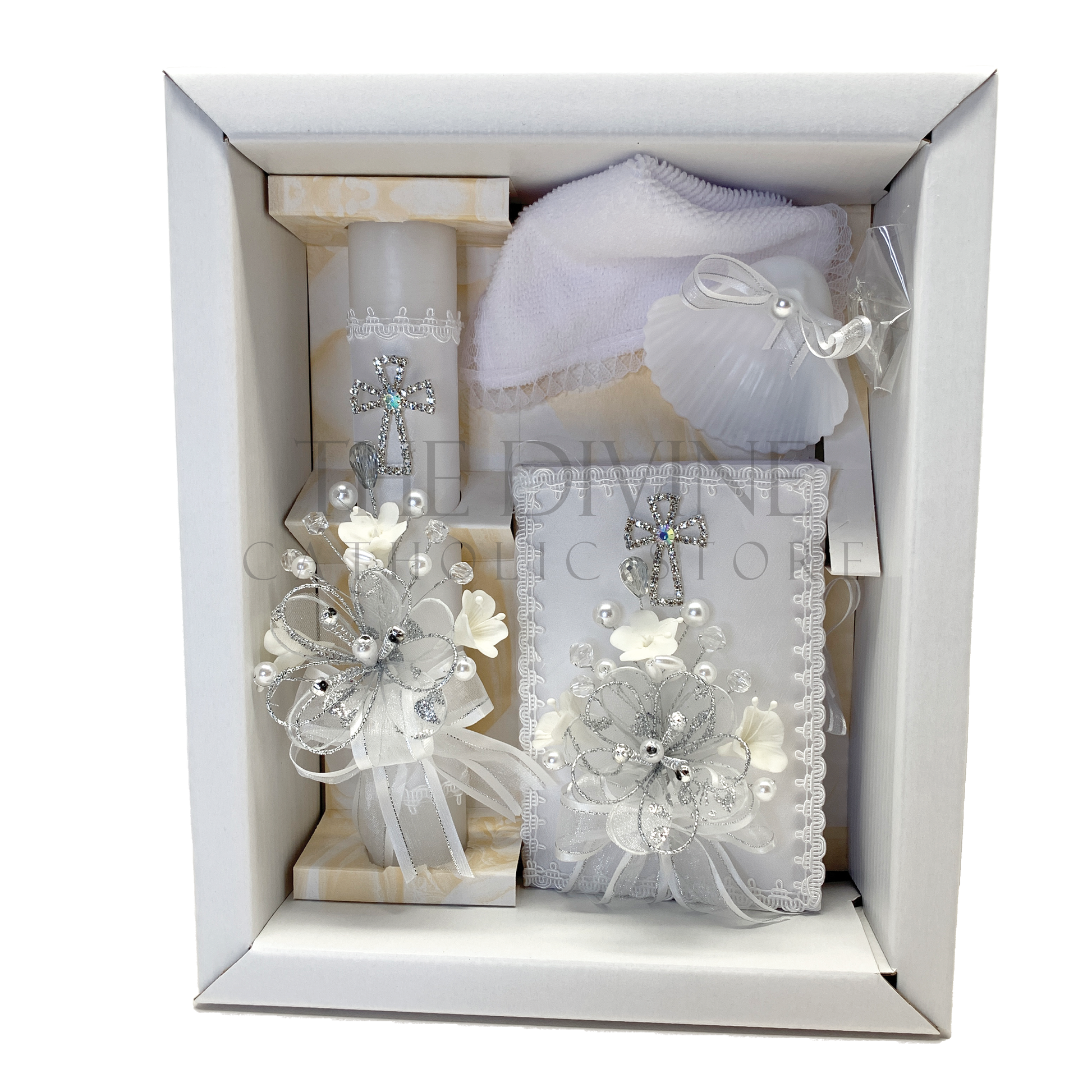 Close up of ivory baptism candle with rhinestone cross bow and floral accents Catholic christening set
