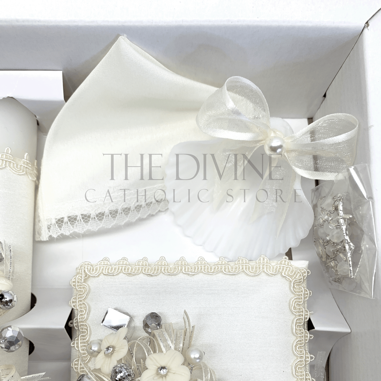 Overhead view of ivory Catholic baptism set style 56 showing candle Bible rosary shell and handkerchief in box
