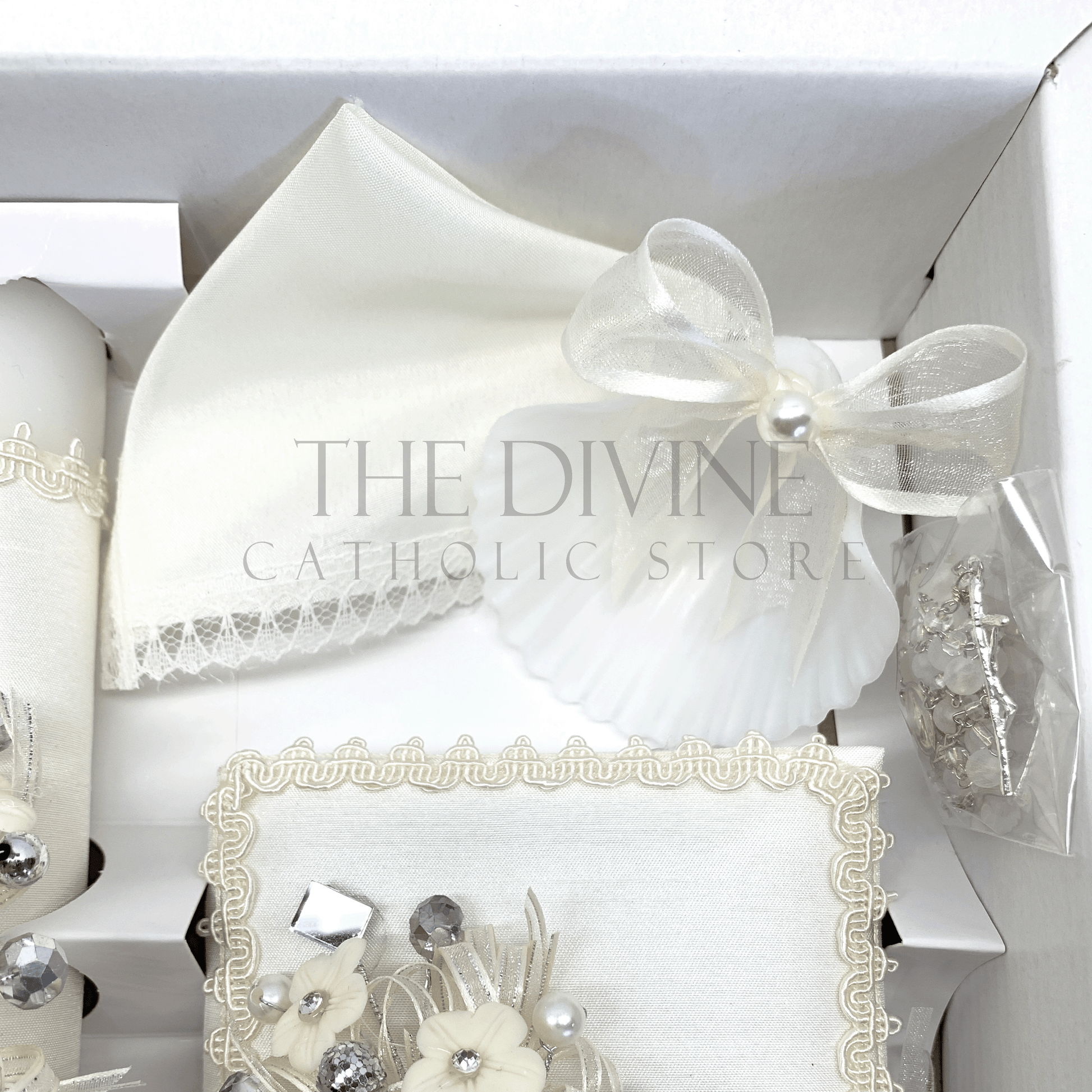 Overhead view of ivory Catholic baptism set style 56 showing candle Bible rosary shell and handkerchief in box
