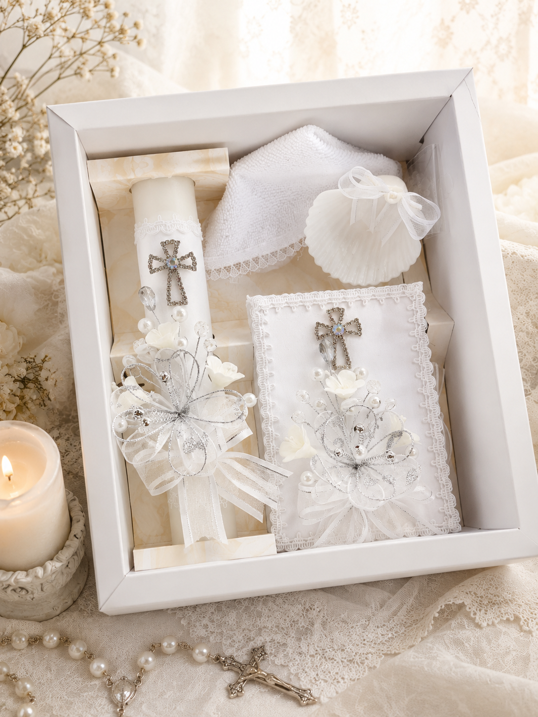 Ivory Catholic baptism candle set displayed in a gift box with matching prayer book, baptism shell, rosary, and ceremonial towel.