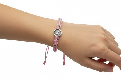 Pink St. Benedict bracelet on wrist, adjustable Catholic beaded bracelet for women with silver medal charm
