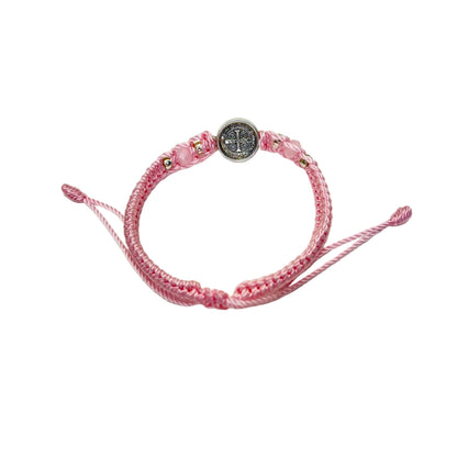 Back detail of pink St. Benedict bracelet showing engraved medal and braided adjustable cord
