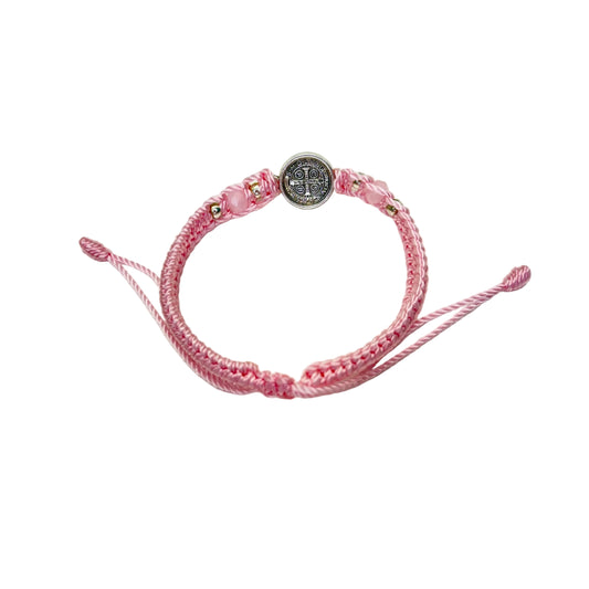 Back detail of pink St. Benedict bracelet showing engraved medal and braided adjustable cord

