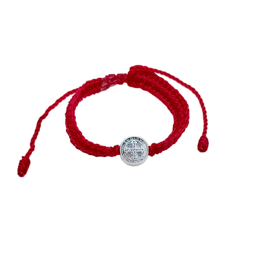 Red St. Benedict baby bracelet with thick woven cord and silver medal centerpiece on white background