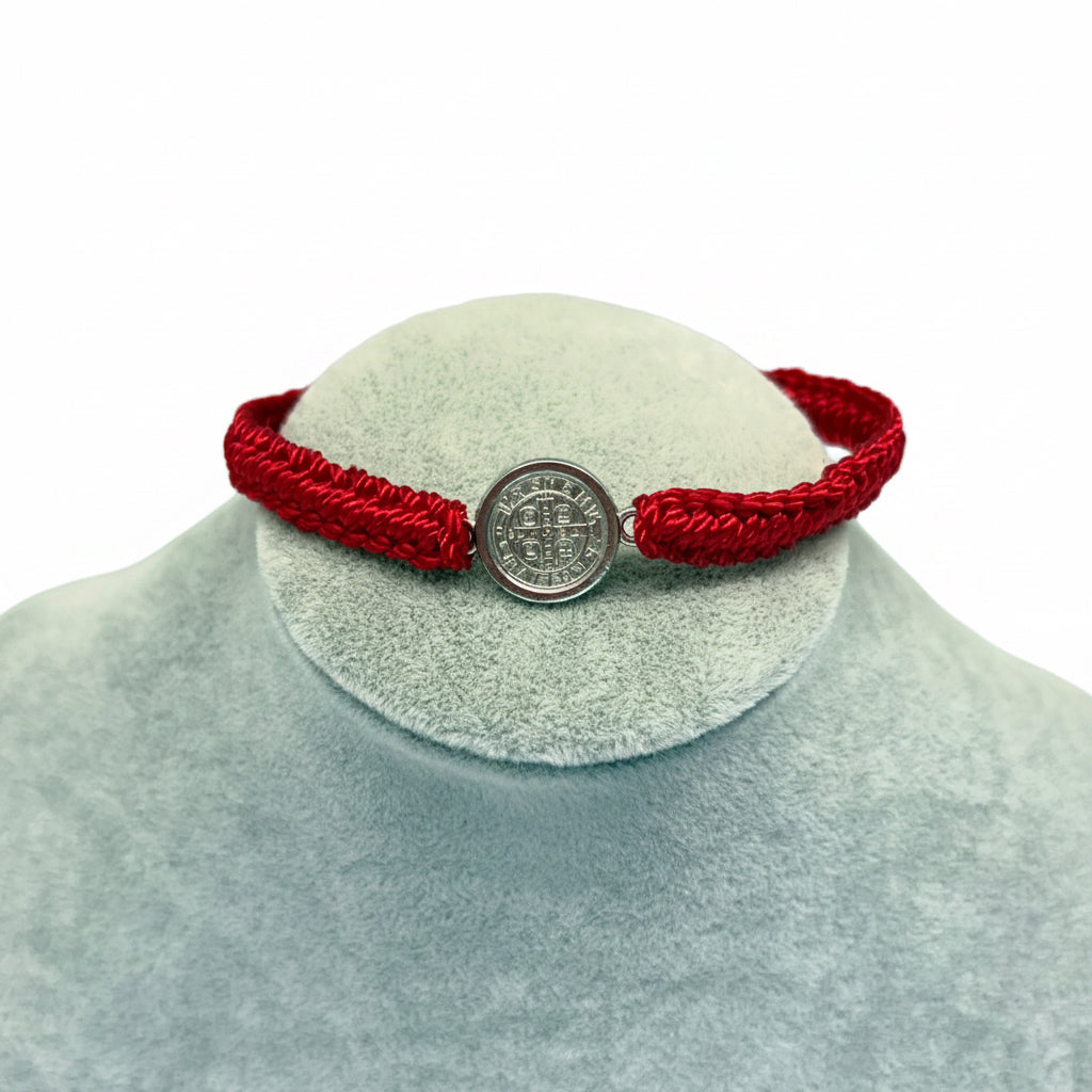 Red St. Benedict bracelet large medal style on display stand, adjustable nylon Catholic bracelet