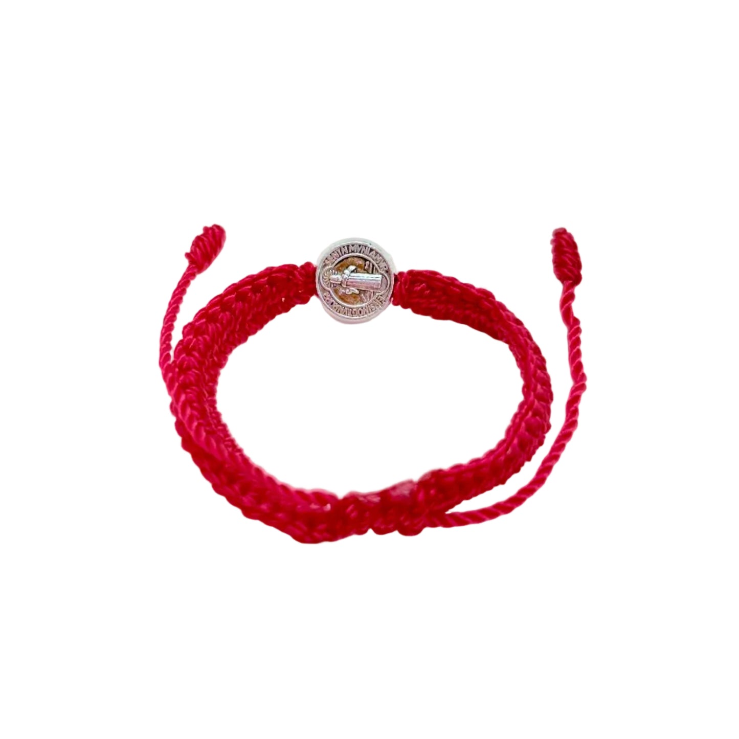 Back view of St. Benedict medal on red woven baby bracelet showing detailed engraving