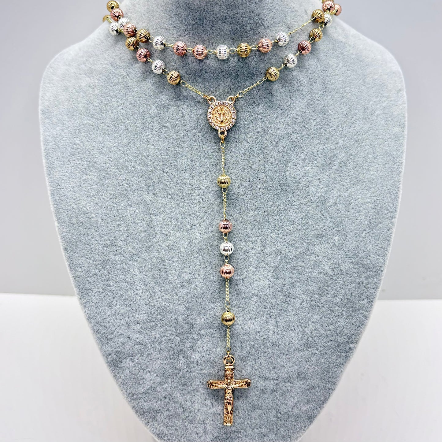 Tri-color St Benedict rosary necklace with textured beads and crucifix on gray display stand 19 inch Catholic jewelry