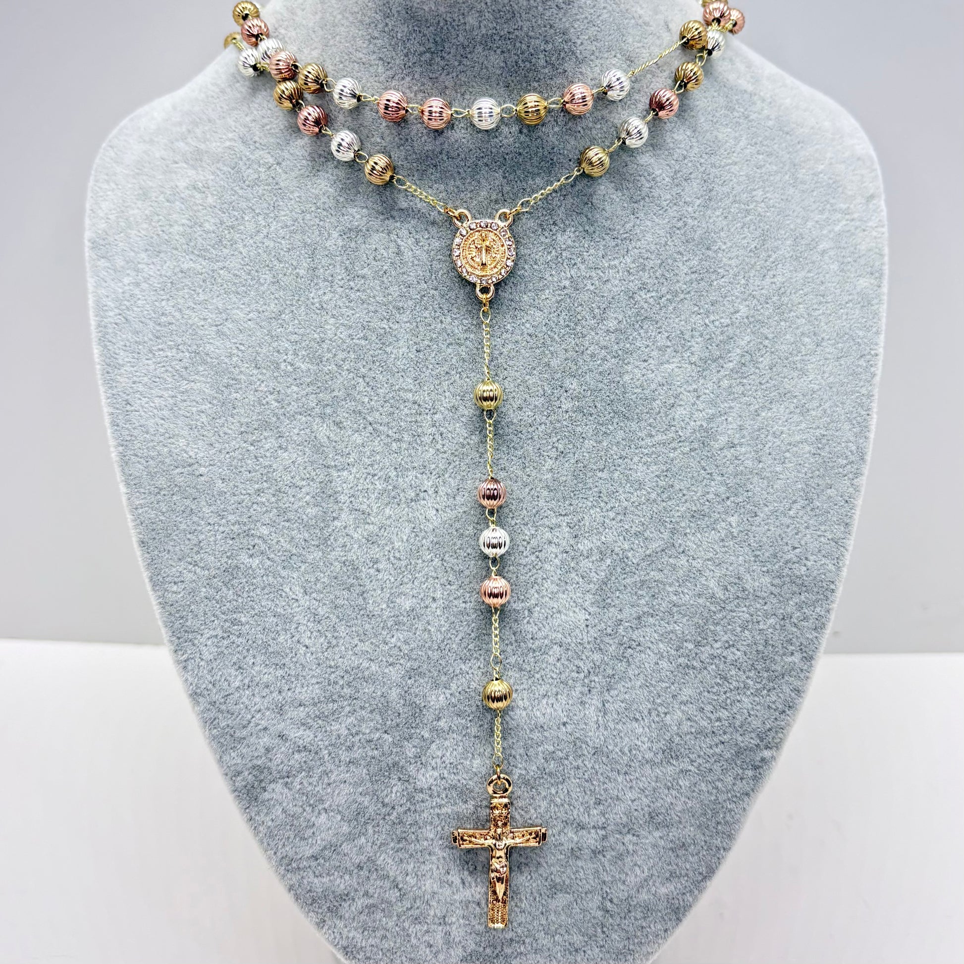 Tri-color St Benedict rosary necklace with textured beads and crucifix on gray display stand 19 inch Catholic jewelry