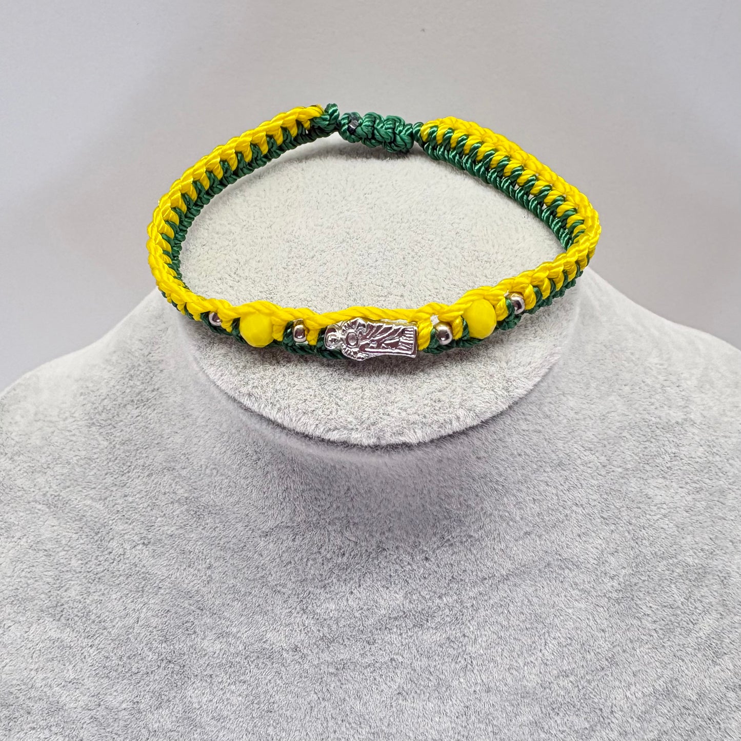 St Jude green and yellow bracelet with crystal beads displayed on jewelry stand Catholic unisex bracelet

