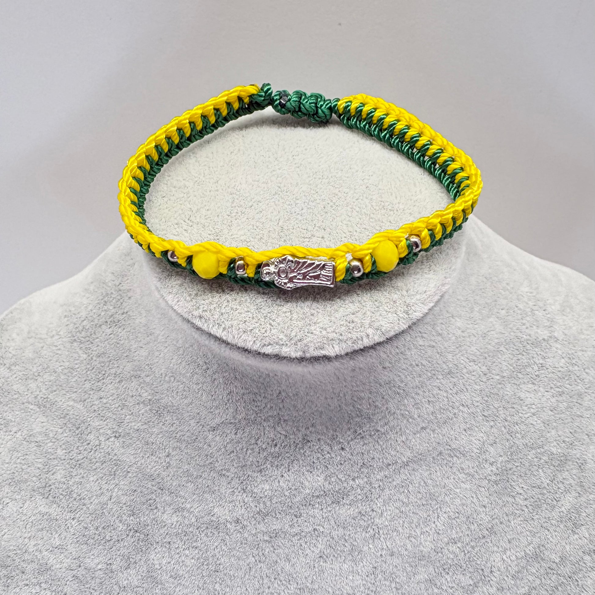 St Jude green and yellow bracelet with crystal beads displayed on jewelry stand Catholic unisex bracelet
