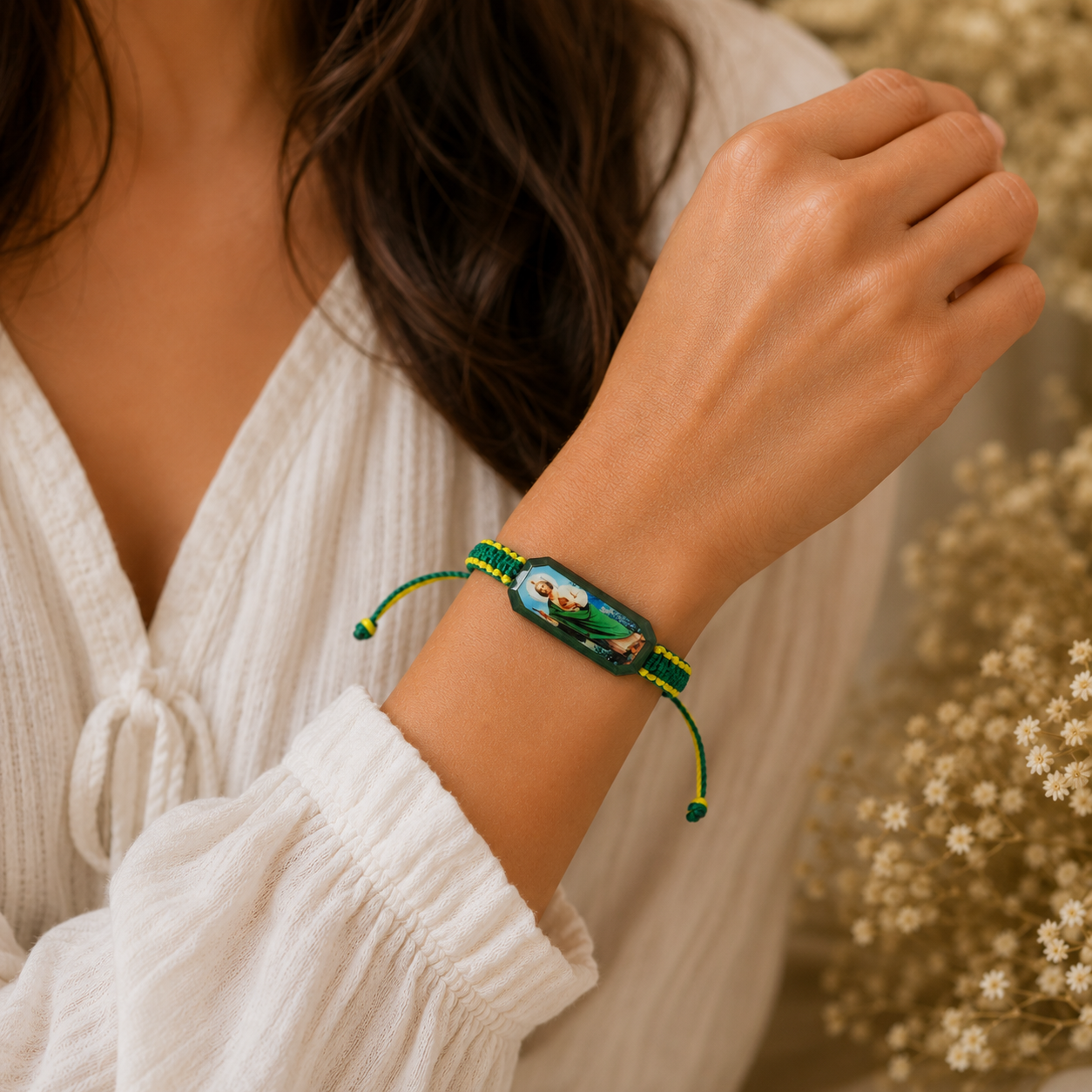 Woman wearing adjustable St Jude green and yellow bracelet on wrist Catholic daily wear accessory