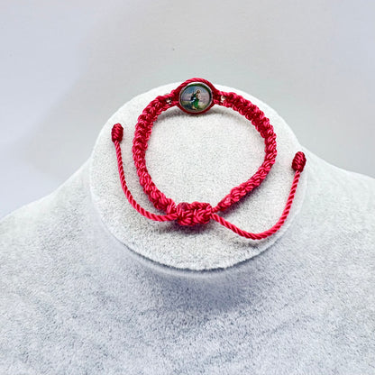 Back view of red St. Jude bracelet showing adjustable knot closure and woven cord detail on display stand